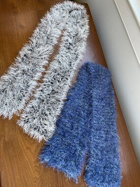 Set of two handmade scarves in eyelash yarn, one medium blue, one black/white